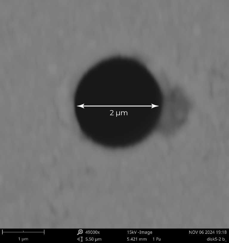 Laser drilled 2 micron hole